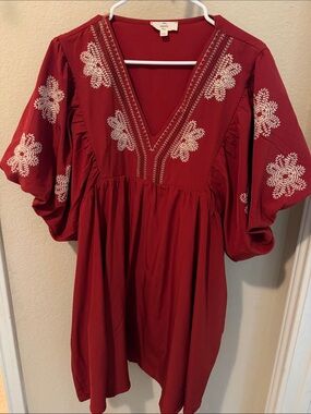 Entro  not quite red/ dark orange. Dress with White Embroidery